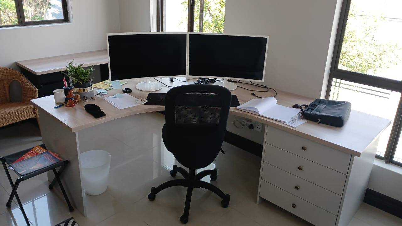 an office with two computer monitors and a chair